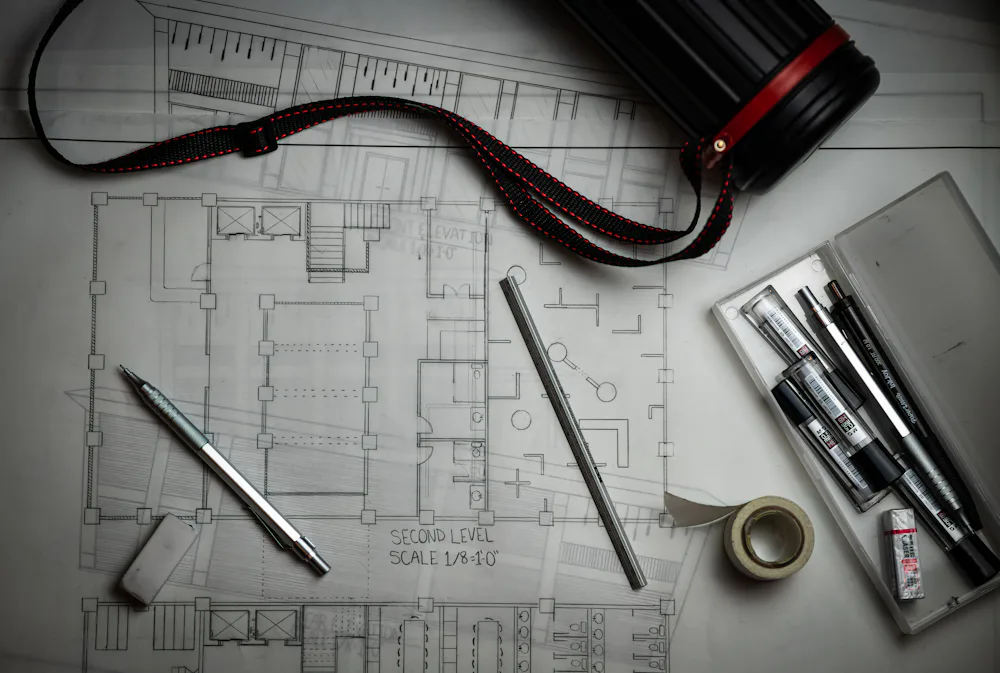 Structural drawings and drafting tools on a desk